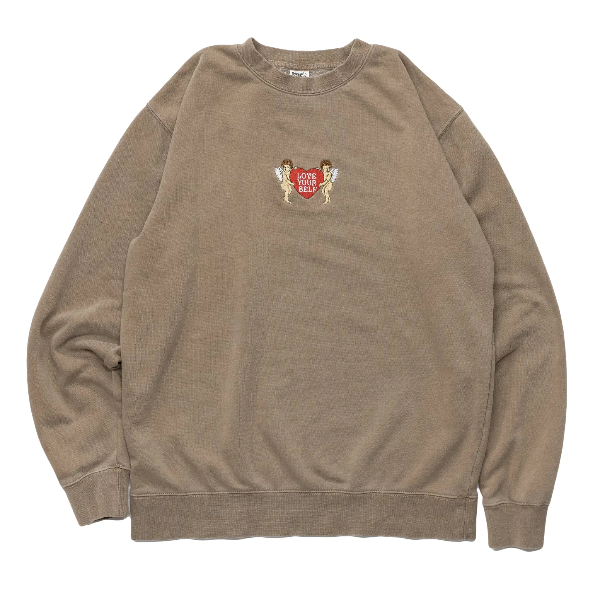 Front view of a clay crewneck sweatshirt by Regular Magic featuring a small center-chest embroidery of cherubs holding a red heart with 'LOVE YOUR SELF' text.