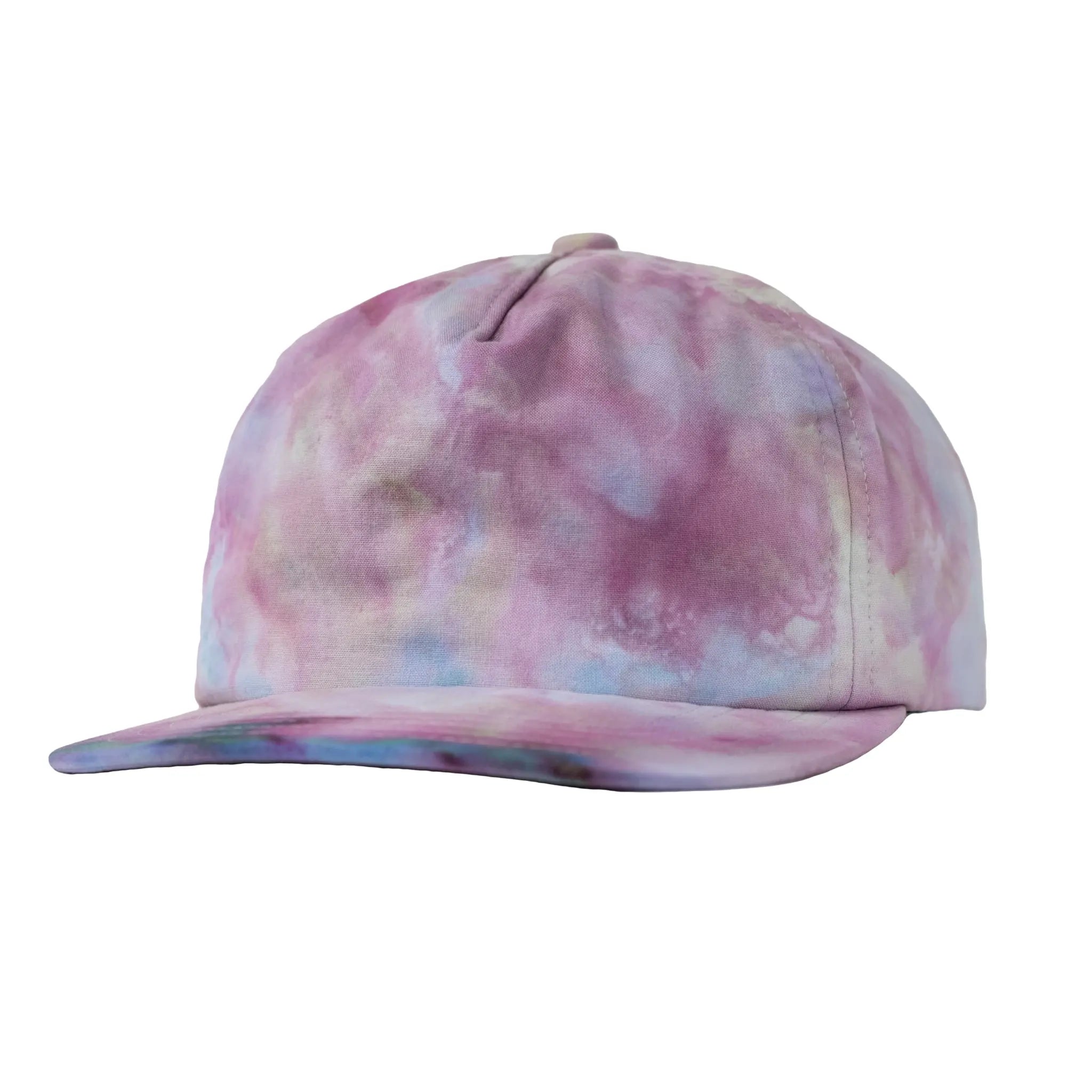 Front profile view of a Regular Magic pastel tie-dye 6 panel baseball cap featuring pink, purple, and light blue watercolor dye patterns with a flat brim.