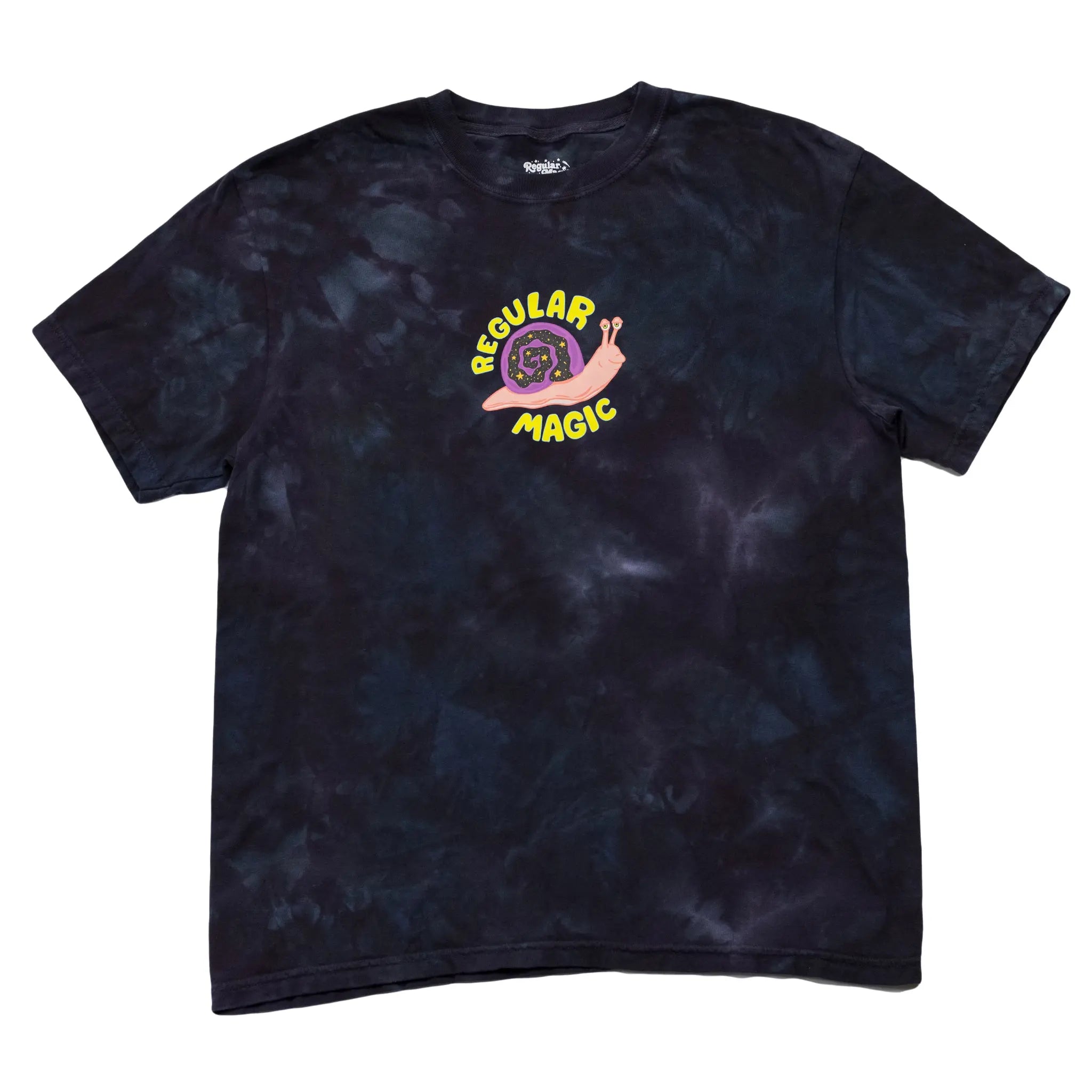 Front view of a dark tie-dye t-shirt by Regular Magic featuring a central chest graphic of Reggie the snail with a starry shell framed by yellow 'Regular Magic' arched text.