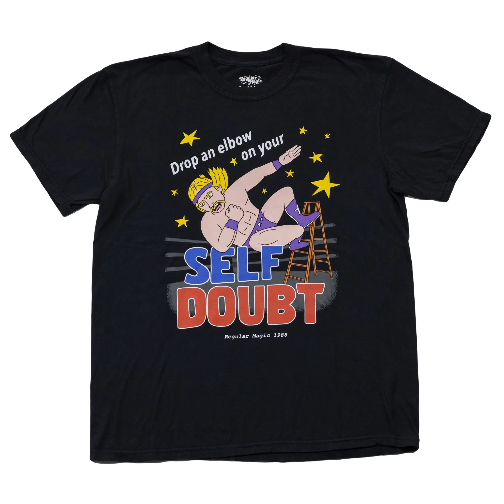 Front view of a black t-shirt by Regular Magic featuring a wrestler dropping an elbow off a ladder, with text reading 'Drop an elbow on your SELF DOUBT'.
